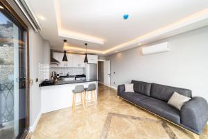 a living room with a couch and a kitchen at Sea View Flat with Hot Tub in Antalya Kas in Kas