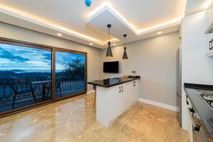 a kitchen with a counter and a large window at Flat with Jacuzzi and Sea View in Kas Antalya in Kas