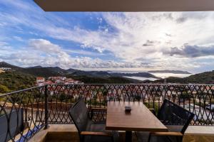 a balcony with a wooden table and chairs and a view at Full Furnished Flat with Sea View in Kas Antalya in Kas