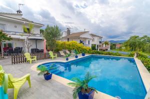 a swimming pool in the backyard of a house at Club Villamar - Residencial Park in Maçanet de la Selva