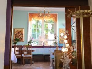 a dining room with a table and a window at Hotel Hölscher in Solingen