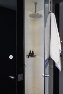 a bathroom with a shower with a glass door at Sir Albert Hotel, part of Sircle Collection in Amsterdam