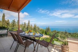 una mesa y sillas en un patio con vistas en DN Beach Coast Villa, en Skinária