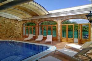 a patio with a swimming pool and chairs at Club Villamar - La Gamba in Sant Feliu de Guixols