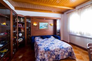 a bedroom with a bed with a blue bedspread at Club Villamar - La Gamba in Sant Feliu de Guixols +22 photos