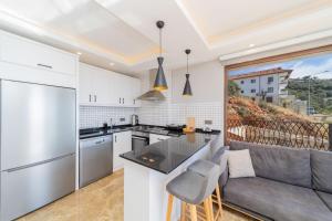 a kitchen and living room with a couch and a table at Fully Furnished Flat with Sea View in Kas Antalya in Kas