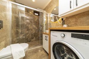 a bathroom with a washing machine and a shower at Fully Furnished Flat with Sea View in Kas Antalya in Kas