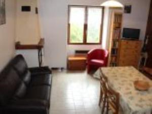 a living room with a couch and a table at La Grange in Condamine-Châtelard