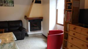 a living room with a couch and a fireplace at La Grange in Condamine-Châtelard