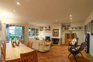 a living room with a table and a couch at Club Villamar - El Far in Llafranc