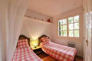 a bedroom with two beds and a window at Club Villamar - El Far in Llafranc +31 photos
