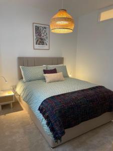 a bedroom with a bed and a chandelier at Victoria Apartment 2 in Torquay