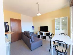 a living room with a couch and a table at Lake Escape - Fuga sul lago in Baveno