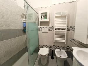 a bathroom with a toilet and a sink at Lake Escape - Fuga sul lago in Baveno +12 photos
