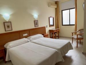 Postel nebo postele na pokoji v ubytování Hotel Cabello