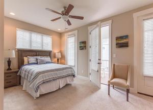 a bedroom with a bed and a ceiling fan at 406B The North End House in Virginia Beach