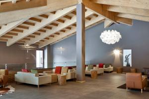 a large lobby with couches and a chandelier at Blu Hotel Acquaseria in Ponte di Legno