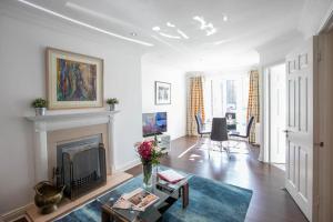 a living room with a fireplace and a table at Grand Canal District Apartments in Dublin