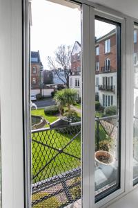 an open window with a view of a yard at Grand Canal District Apartments in Dublin