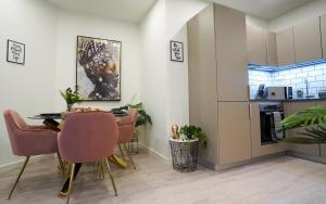 a kitchen and dining room with a table and chairs at Spacious Luxury Apartment in Stevenage, Sleeps 6, with Free Parking, and Free Wi-Fi in Stevenage