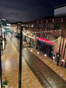 an empty city street at night with a building at The Flat on Humber Street in Hull