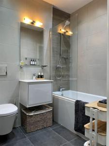 uma casa de banho com uma banheira, um lavatório e um WC. em The Flat on Humber Street em Hull