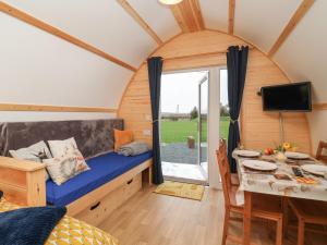 a room with a bed and a dining room with a table at Covey in Harpham
