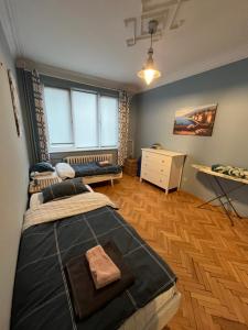 a bedroom with two beds and a desk in it at Your Space in Sofia in Sofia