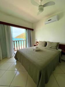 a bedroom with a bed with a view of the ocean at Orlanova Hotel in Arraial do Cabo +98 photos