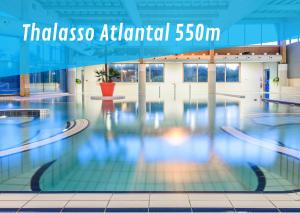 a swimming pool with the words thulsos atlanta annual at Maison des Dunes, T2, proche plage et forêt in Anglet
