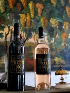 two bottles of wine sitting on a table at Hôtel Villa Walbaum in Vallon-Pont-dʼArc