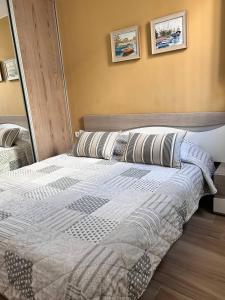 a bed in a bedroom with two pillows on it at Apartment Virginia in Playa de las Americas