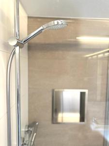 a silver lamp in a bathroom next to a sink at Hotel Ochsen in Friesenheim