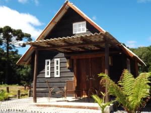 Cabaña de madera pequeña con techo en RECANTO DO SINALEIRO GRAMADO, en Gramado