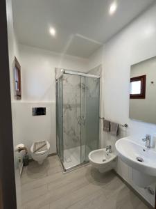 a bathroom with a shower and a toilet and a sink at Studio's Pavese in Olbia