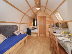 a room with a bed and a table in a tiny house at Husk in Harpham