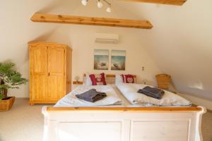 a bedroom with a white bed with pillows on it at Amelie in Zingst