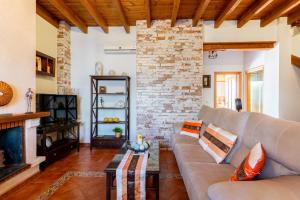a living room with a couch and a fireplace at vll Vivienda rural a las puertas de Doñana in Villamanrique de la Condesa