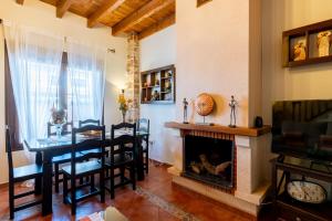 a living room with a table and a fireplace at vll Vivienda rural a las puertas de Doñana in Villamanrique de la Condesa