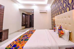 a bedroom with a large bed in a room at FabHotel Swess Grand in Agra