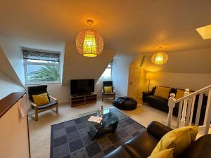 a living room with a couch and a table at Southover Beach in Woolacombe