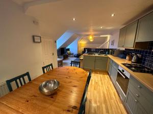 a kitchen with a wooden table with a bowl on it at Southover Beach in Woolacombe