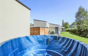 a house with a blue pool in front of a house at Awesome Home In Lembruchdümmer See in Lembruch +35 photos