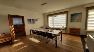a dining room with a table and some chairs at Villa Duinberg R-002 in Koksijde