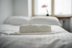 a stack of towels sitting on top of a bed at JM Rooms Lubicz II in Krakow