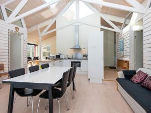 a dining room and kitchen with a table and chairs at Holiday home Vemb VI in Vemb