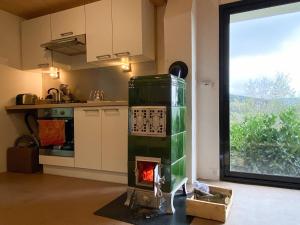 a kitchen with a stove in the middle of a room at Gîte Les Ebeteux in Fraize