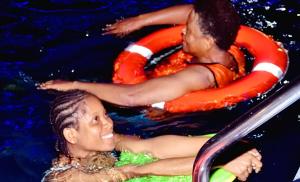 two girls in the water in a pool at The Agore Hotels and Suites Ltd in Awoyaya