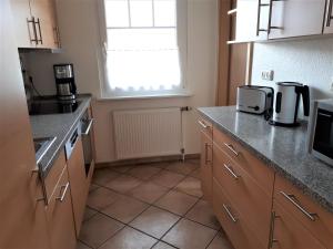 a kitchen with a sink and a counter top at Ferienhaus Hopp in Fehmarn