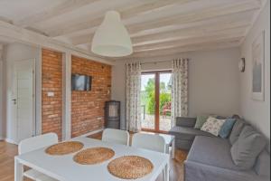 a living room with a table and a couch at Nadmorska Osada in Łeba